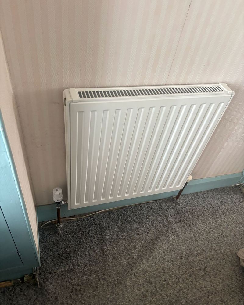 New radiator fitted in a bedroom